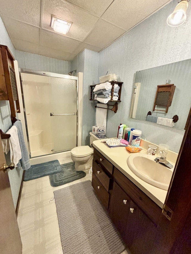 5356 Spruce Dr, Lewiston, MI 49756 - full bath with a paneled ceiling, vanity, a shower stall, toilet, and tile patterned floors