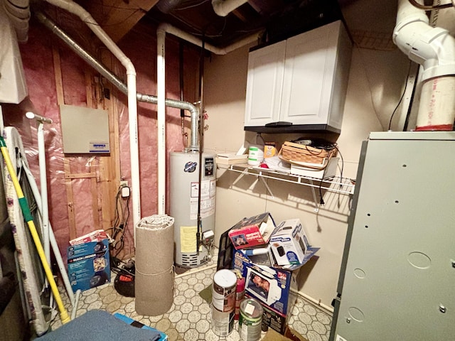 5356 Spruce Dr, Lewiston, MI 49756 - unfinished below grade area featuring gas water heater and tile patterned floors