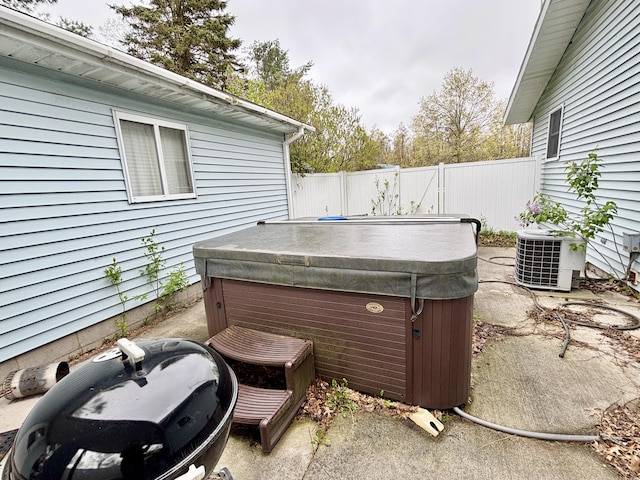 5356 Spruce Dr, Lewiston, MI 49756 - view of patio with a hot tub and central AC