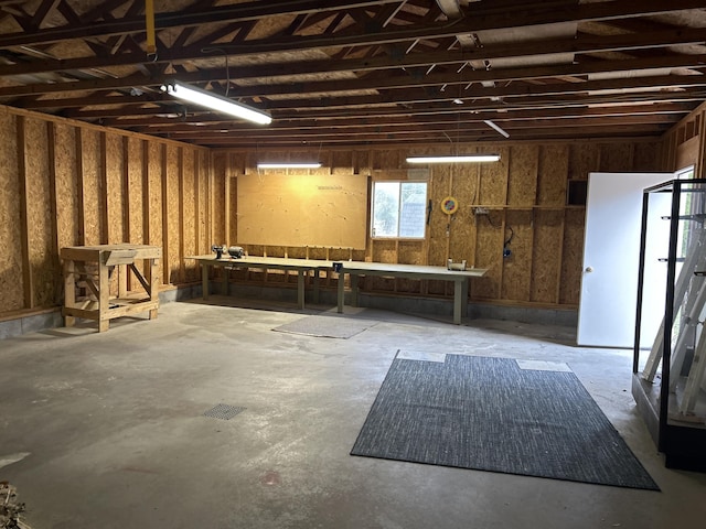 2323 Hobbs Dr, Alpena, MI 49707 - miscellaneous room with a workshop area, a garage, and concrete flooring
