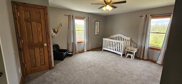 2460 Hamilton Rd, Alpena, MI 49707 - bedroom with carpet, a nursery area, baseboards, and ceiling fan