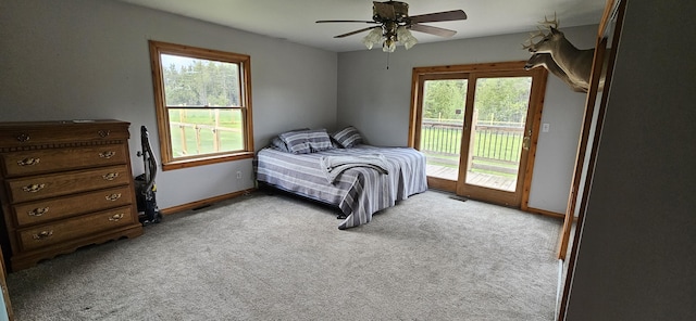 2460 Hamilton Rd, Alpena, MI 49707 - bedroom featuring access to outside, light carpet, and baseboards