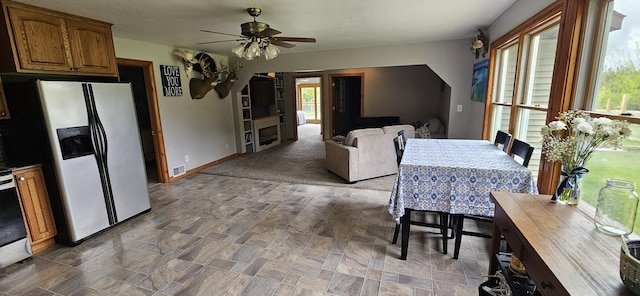 2460 Hamilton Rd, Alpena, MI 49707 - dining room with plenty of natural light, a ceiling fan, and baseboards