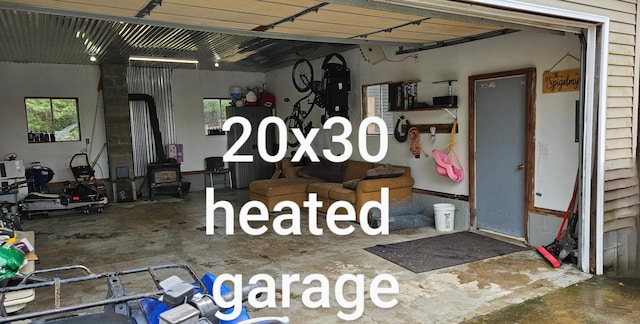 2460 Hamilton Rd, Alpena, MI 49707 - garage featuring a wood stove