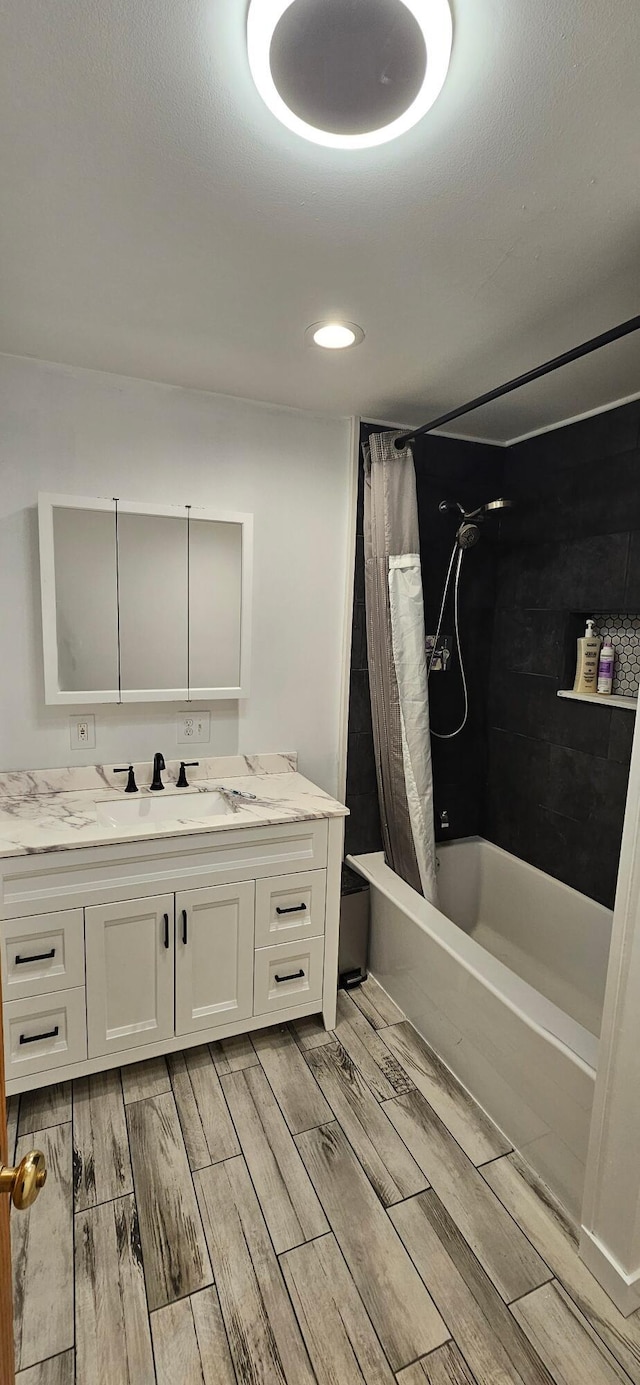 2460 Hamilton Rd, Alpena, MI 49707 - full bathroom with vanity, wood tiled floors, shower / bath combo, and recessed lighting