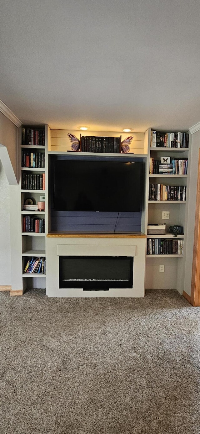 2460 Hamilton Rd, Alpena, MI 49707 - unfurnished living room with a fireplace, crown molding, carpet flooring, and baseboards