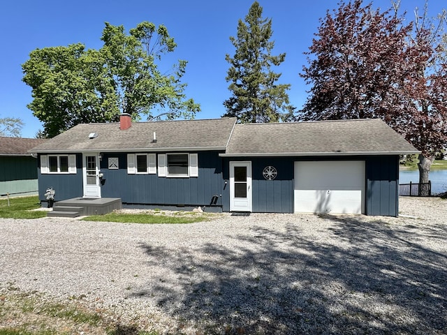 9452 M33, Cheboygan, MI 49721 - single story home with a garage, a shingled roof, and gravel driveway