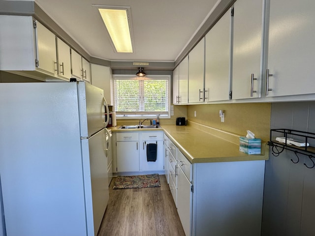 9452 M33, Cheboygan, MI 49721 - kitchen featuring freestanding refrigerator, dark wood finished floors, white cabinetry, and light countertops