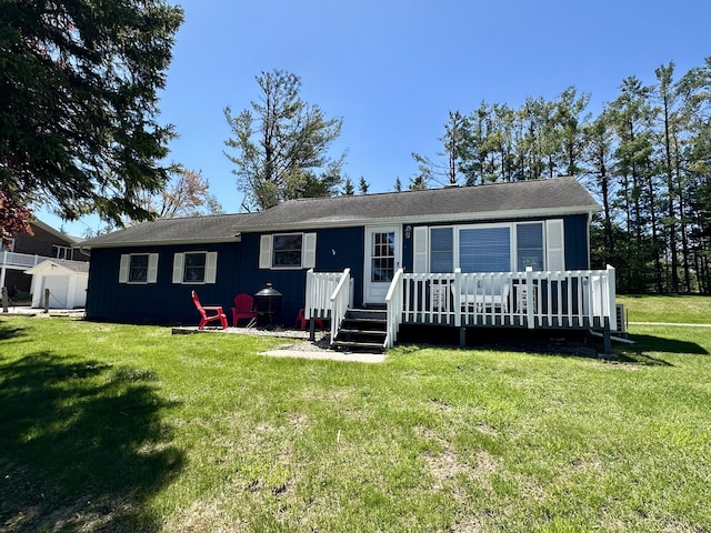 9452 M33, Cheboygan, MI 49721 - view of front facade with a wooden deck and a front lawn