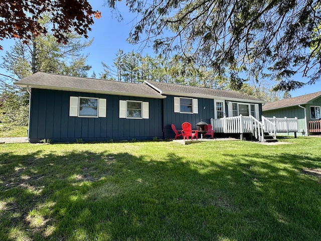 9452 M33, Cheboygan, MI 49721 - view of front of house featuring a deck, board and batten siding, and a front yard