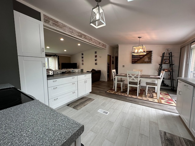1085 Five Lakes Rd, Gaylord, MI 49735 - kitchen featuring healthy amount of natural light, dark countertops, light wood-style flooring, recessed lighting, and ornamental molding
