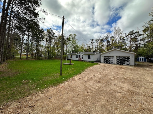 1085 Five Lakes Rd, Gaylord, MI 49735 - view of front of home with a garage and a front lawn