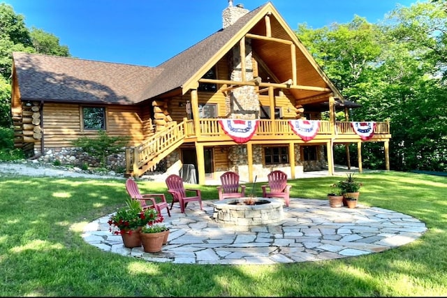 10924 E Grand Lake Rd, Presque Isle, MI 49777 - back of house featuring log exterior, an outdoor fire pit, a lawn, stairs, and a patio
