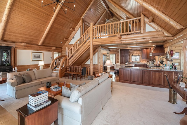 10924 E Grand Lake Rd, Presque Isle, MI 49777 - living area featuring high vaulted ceiling, wooden ceiling with exposed beams, log walls, stairway, and a wainscoted wall