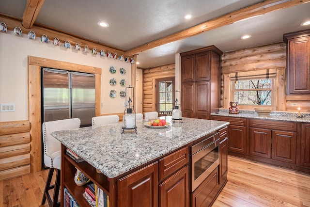 10924 E Grand Lake Rd, Presque Isle, MI 49777 - kitchen with rustic walls, stainless steel appliances, beam ceiling, healthy amount of natural light, and light wood finished floors