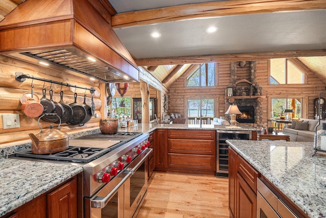 10924 E Grand Lake Rd, Presque Isle, MI 49777 - kitchen featuring range with two ovens, rustic walls, beverage cooler, custom exhaust hood, and healthy amount of natural light