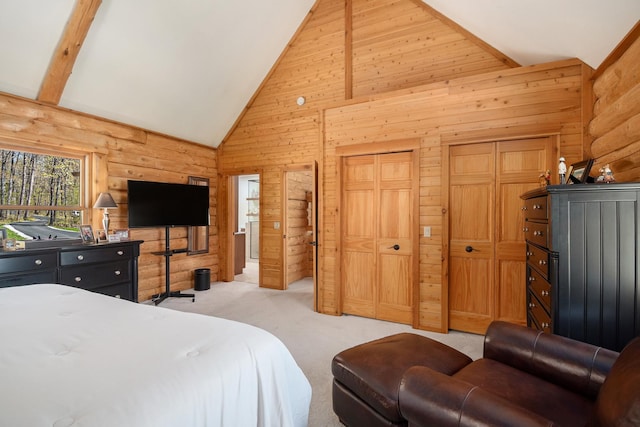 10924 E Grand Lake Rd, Presque Isle, MI 49777 - bedroom with wooden walls, light colored carpet, multiple closets, beam ceiling, and high vaulted ceiling