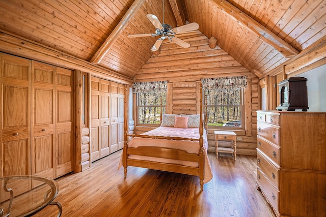 10924 E Grand Lake Rd, Presque Isle, MI 49777 - bedroom featuring multiple windows, rustic walls, wood ceiling with exposed beams, light wood finished floors, and high vaulted ceiling