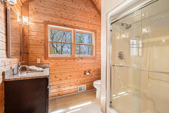 10924 E Grand Lake Rd, Presque Isle, MI 49777 - bathroom featuring vanity, wooden walls, a stall shower, and toilet