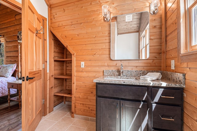 10924 E Grand Lake Rd, Presque Isle, MI 49777 - bathroom featuring vanity, wooden walls, tile patterned floors, and lofted ceiling