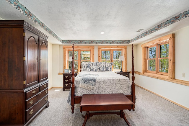 10924 E Grand Lake Rd, Presque Isle, MI 49777 - bedroom featuring light carpet, a textured ceiling, baseboards, and a tray ceiling