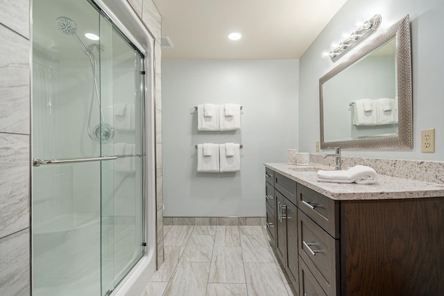 10924 E Grand Lake Rd, Presque Isle, MI 49777 - bathroom featuring vanity, a stall shower, marble look tiles, recessed lighting, and baseboards
