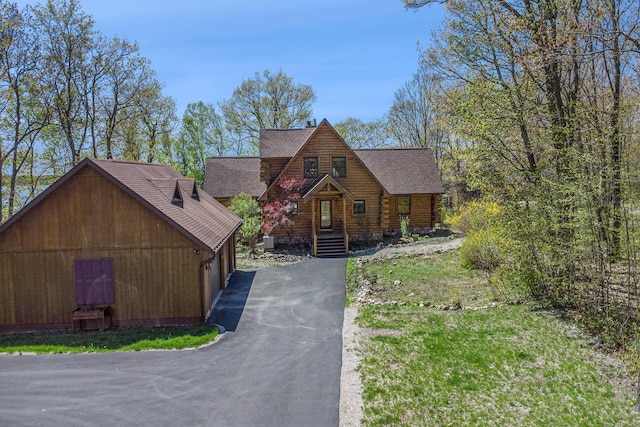 10924 E Grand Lake Rd, Presque Isle, MI 49777 - log home with driveway, a shingled roof, and log siding