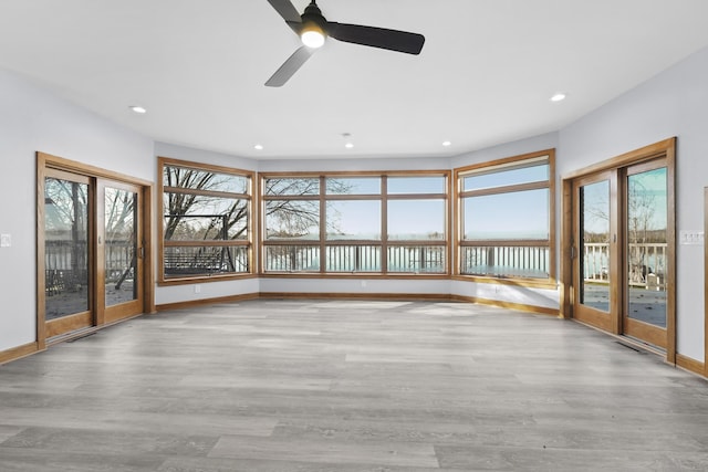 4348 W Lakeside Dr, West Branch, MI 48661 - unfurnished sunroom with a water view, wood finished floors, recessed lighting, baseboards, and french doors