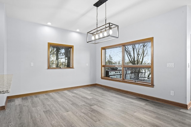 4348 W Lakeside Dr, West Branch, MI 48661 - unfurnished dining area with wood finished floors, baseboards, and recessed lighting