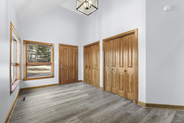 4348 W Lakeside Dr, West Branch, MI 48661 - entrance foyer featuring high vaulted ceiling, wood finished floors, and baseboards