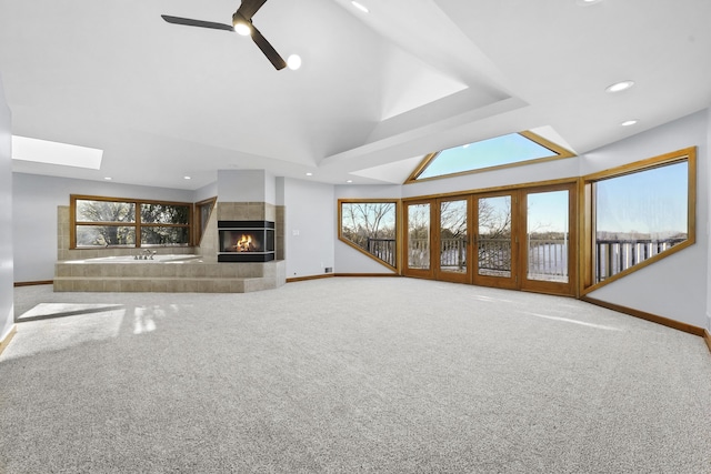 4348 W Lakeside Dr, West Branch, MI 48661 - unfurnished living room with baseboards, recessed lighting, carpet floors, a tiled fireplace, and ceiling fan