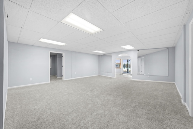4348 W Lakeside Dr, West Branch, MI 48661 - below grade area with a paneled ceiling, carpet, arched walkways, and baseboards