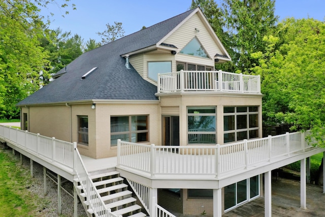 4348 W Lakeside Dr, West Branch, MI 48661 - back of house featuring a balcony, a shingled roof, stairway, and brick siding
