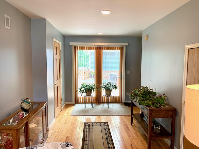 132 16th St, Prudenville, MI 48651 - doorway to outside featuring light wood-style flooring, baseboards, and recessed lighting