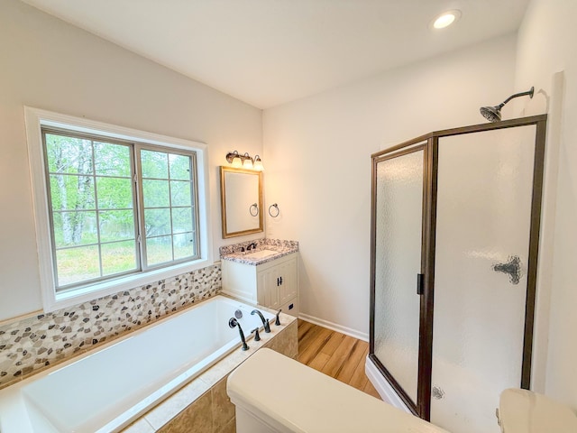 116 No Wake Ct, Houghton Lake, MI 48629 - bathroom with a stall shower, vanity, wood finished floors, a bath, and recessed lighting