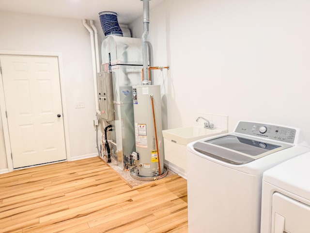 116 No Wake Ct, Houghton Lake, MI 48629 - washroom featuring independent washer and dryer, water heater, and light wood-type flooring