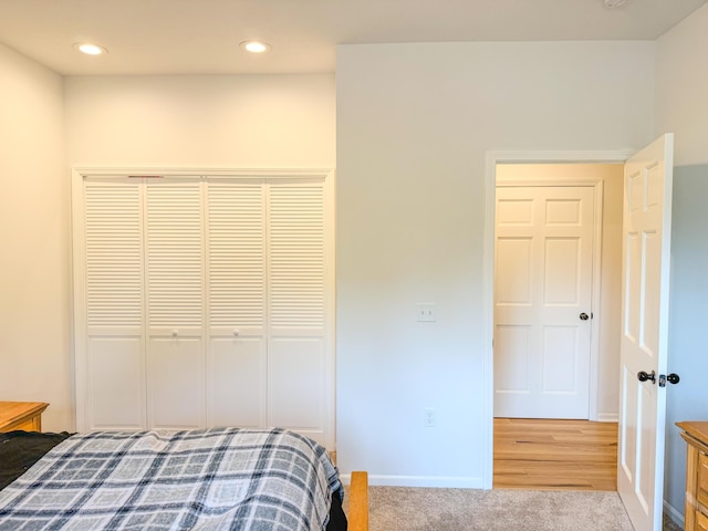 116 No Wake Ct, Houghton Lake, MI 48629 - bedroom featuring a closet, baseboards, recessed lighting, and wood finished floors