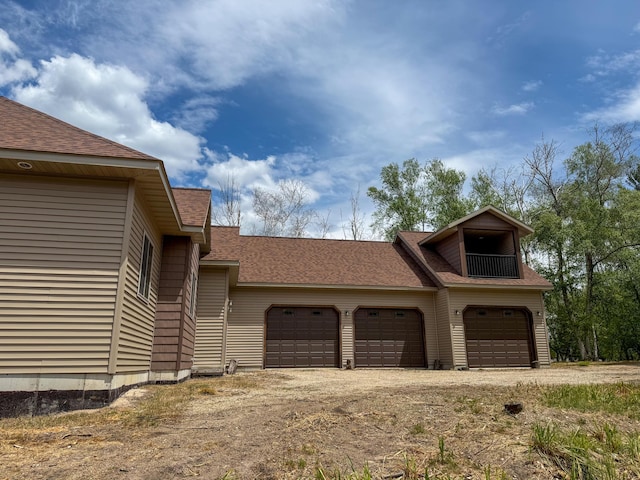 116 No Wake Ct, Houghton Lake, MI 48629 - view of property exterior with driveway, a garage, and roof with shingles