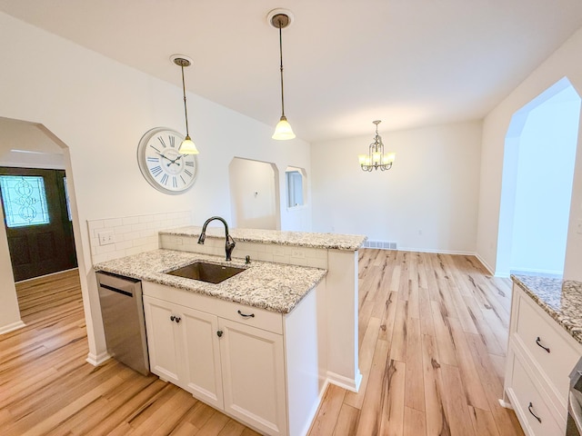 116 No Wake Ct, Houghton Lake, MI 48629 - kitchen featuring a sink, light wood-style flooring, a peninsula, dishwasher, and tasteful backsplash