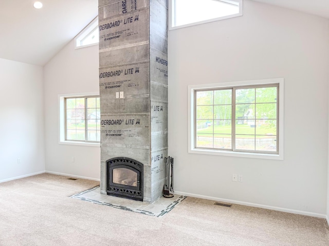 116 No Wake Ct, Houghton Lake, MI 48629 - unfurnished living room with high vaulted ceiling, carpet flooring, baseboards, and a tile fireplace