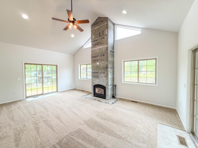 116 No Wake Ct, Houghton Lake, MI 48629 - unfurnished living room with high vaulted ceiling, light colored carpet, ceiling fan, baseboards, and a tiled fireplace