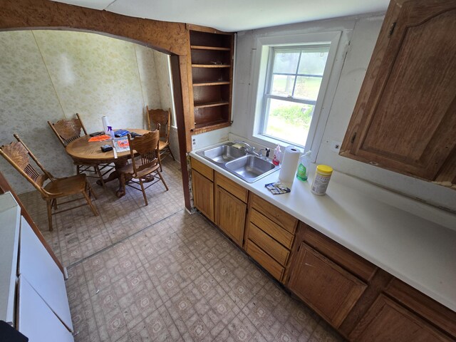 903 W 8th St, Mio, MI 48647 - kitchen featuring a sink, light countertops, brown cabinets, and open shelves