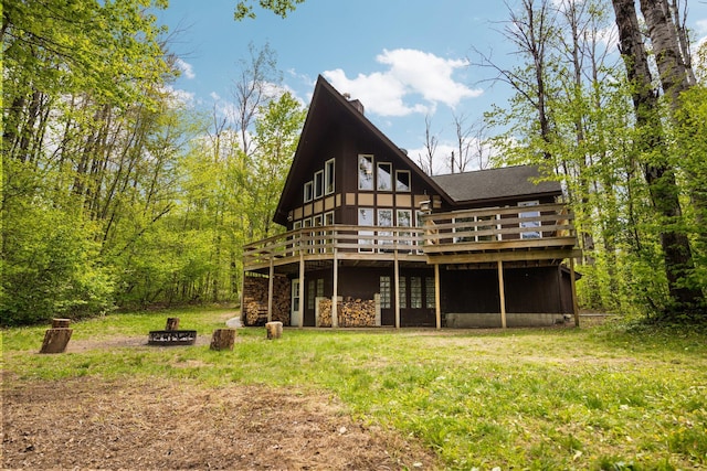 6192 Wilderness Dr, Mancelona, MI 49659 - back of house featuring a deck and stone siding