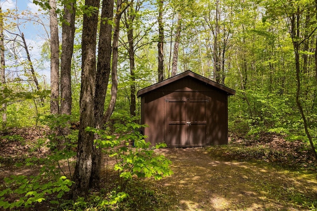 6192 Wilderness Dr, Mancelona, MI 49659 - view of shed featuring a wooded view