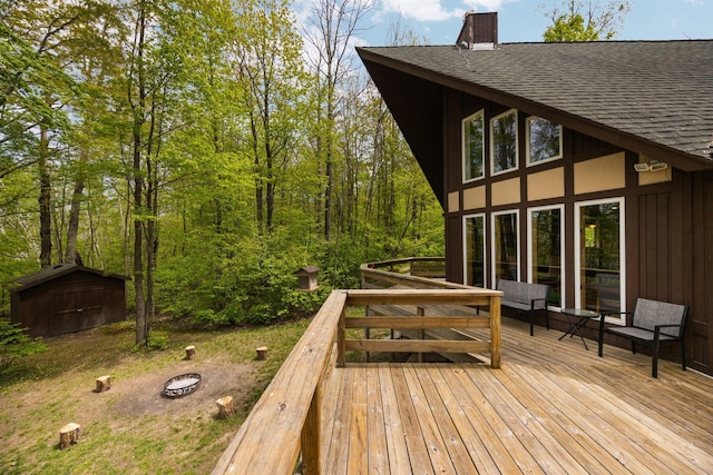 6192 Wilderness Dr, Mancelona, MI 49659 - wooden deck with an outdoor fire pit