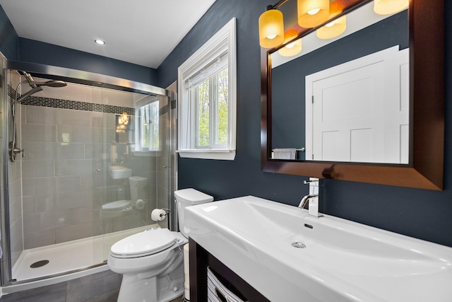 6192 Wilderness Dr, Mancelona, MI 49659 - bathroom featuring toilet, a stall shower, and vanity