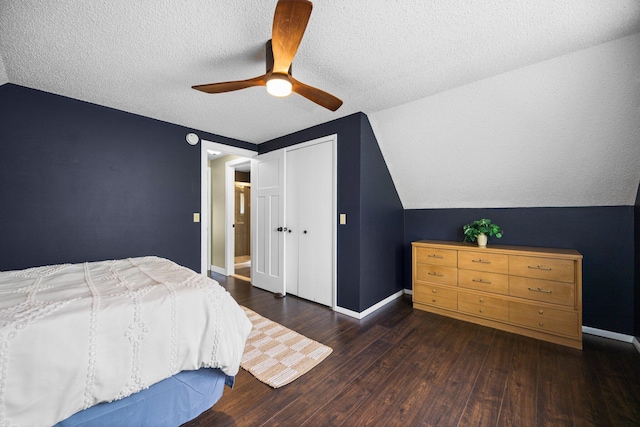 6192 Wilderness Dr, Mancelona, MI 49659 - bedroom featuring vaulted ceiling, wood finished floors, a ceiling fan, a textured ceiling, and baseboards