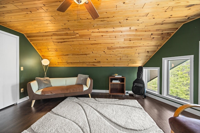6192 Wilderness Dr, Mancelona, MI 49659 - living area with wood ceiling, vaulted ceiling, baseboards, ceiling fan, and wood finished floors
