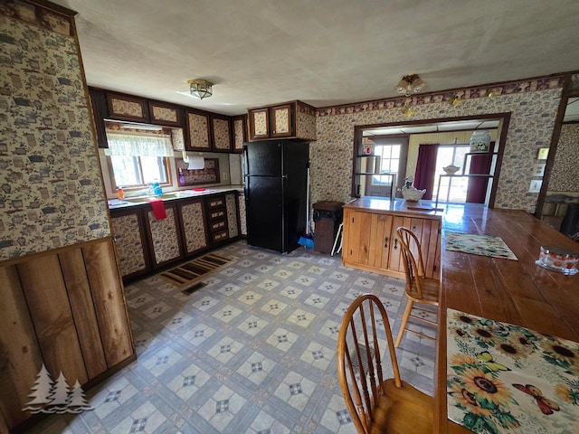 3557 Penn Rd, Lewiston, MI 49756 - kitchen featuring freestanding refrigerator, plenty of natural light, and wallpapered walls