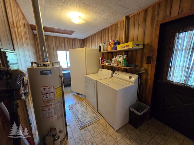 3557 Penn Rd, Lewiston, MI 49756 - laundry room featuring water heater, washing machine and clothes dryer, light flooring, and wood walls